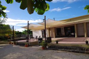 a tent on the front of a house at Belle villa , pieds dans l'eau avec piscine in Terre Rouge