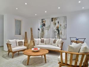 a living room with two couches and a table at Stelia Mare Boutique Hotel in Naousa