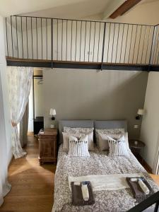 a bedroom with a large bed with a loft at La Quintessenza del Borgo in Varzi