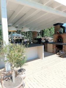 a patio with an outdoor kitchen with a stove at Villa am Wald in Meckenheim