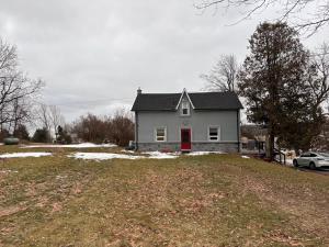 a house with a red door on top of a yard at House on Farm in Rosemonte