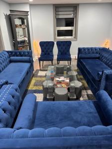 a living room with blue couches and a coffee table at House on Farm in Rosemonte