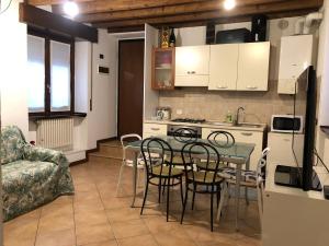 una cucina e una sala da pranzo con tavolo e sedie di La casetta della felicità, comodità tra Milano e Bergamo a Capriate San Gervasio