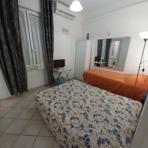 a bedroom with a bed and a desk in it at La Casetta di Paola in Rome