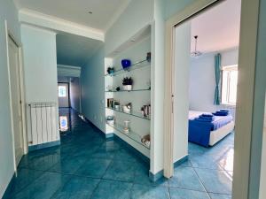 a hallway with a bed and shelves in a room at Bella Tropea Suite in Tropea