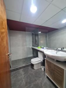 a bathroom with a sink and a toilet and a shower at Appartement avec piscine in Puerto de Mazarrón