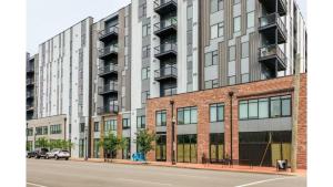 a large building on the side of a street at Stunning Nulu 1BR CozySuites 06 in Louisville