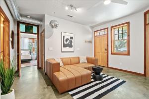a living room with a brown couch and a rug at Urban Cowboy Villas - Heart of 704 in Austin