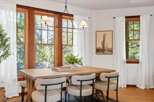 a dining room with a wooden table and chairs at Urban Cowboy Villas - Heart of 704 in Austin