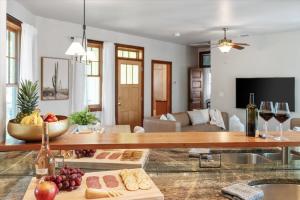 a living room with a table with food and wine glasses at Urban Cowboy Villas - Heart of 704 in Austin +21 photos