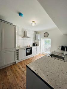 a kitchen with white cabinets and a counter top at Dolgellau Grand Heights Apt in Dolgellau