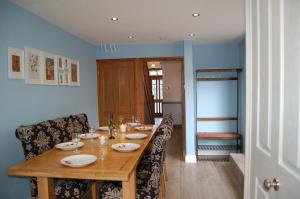 a dining room with a wooden table and chairs at Idris View Family Holiday Home in Tywyn