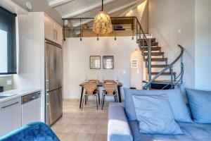 a living room with a couch and a table at Deluxe Seaside Condo for 6 in Kandia