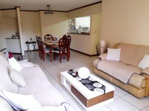 a living room with two couches and a table at Comfortable Apartment with Free Parking in Guatemala