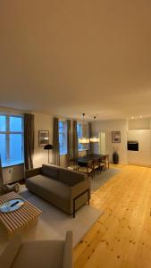 a living room with a couch and a table at Stunning 5 BR Flat by The Lakes in Copenhagen