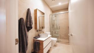 a bathroom with a toilet and a sink and a shower at Beautiful urban apartment 2 in Nelson +5 photos