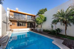 a house with a swimming pool next to a building at Casona en Buenos Aires in Buenos Aires