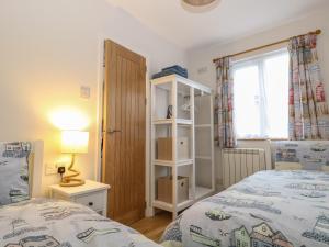 a bedroom with two beds and a window at Sea Urchin in Norwich