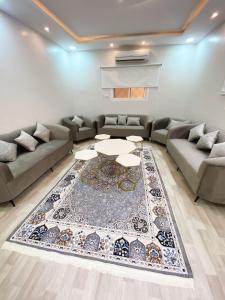 a living room with a couch and a table at الرس in Al Rass