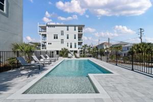 a swimming pool in front of a building at Beachside Bungalow in Destin