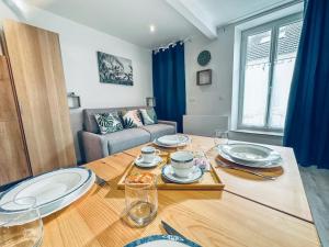a living room with a table with plates on it at Le Héron - Élégance - Confort moderne - 2RFHomes in Château-Thierry