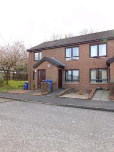 a brick house on a street with a driveway at 2 bed Apt on Quiet Cul-de-Sac, Fab Location in Paisley