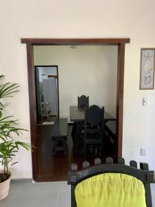 a room with a mirror and a table and a chair at Hostel Vila dos Corais in Arraial do Cabo