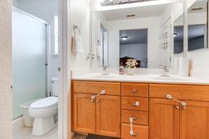 a bathroom with a sink and a toilet and a mirror at Spacious Turlock Home about 1 Mi to University! in Turlock +23 photos