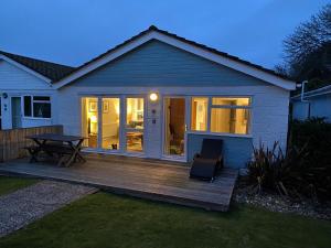 a house with a deck with a table at Jamestown 2 in Yarmouth