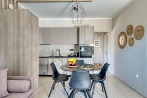 a kitchen and living room with a table and chairs at Deluxe Seaside Condo for 4 in Kandia