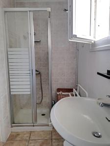 a bathroom with a shower and a toilet and a sink at Villa au cœur de la station - 1540 in Soulac-sur-Mer +22 photos