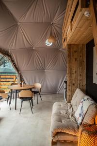 a room with a tent with a table and chairs at BUNNY GLAMP in Korbielów