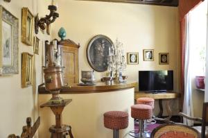 a living room with a tv and some chairs at Hotel San Guido in Milan