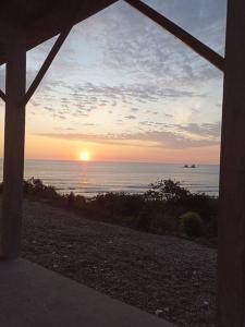 a view of the ocean at sunset from a porch at Ayampe Kachalotes, Beach house, The best view in Ayampe