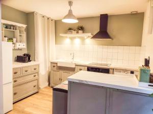 a kitchen with a sink and a counter top at Gites Le 1900 in Val Couesnon