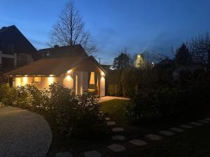 a house with lights on the side of it at night at Lodge Pia in Bled