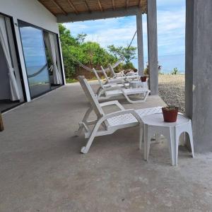 a group of chairs and a table on a patio at Ayampe Kachalotes, Beach house, The best view in Ayampe