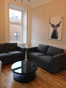 a living room with a couch and a table at Beautiful 3 bed apt in the City Centre in Glasgow