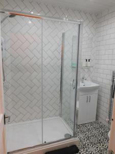 a shower stall in a bathroom with a sink at Beautiful 3 bed apt in the City Centre in Glasgow