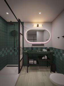 a bathroom with a sink and a mirror at Moxy St. Petersburg Downtown in St. Petersburg
