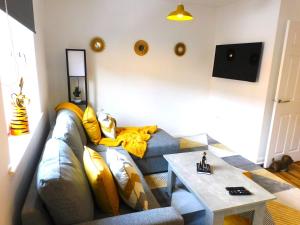 a living room with a couch and a table at Newly refurbished 1 bed Apt in Hamilton Close to station and local amenities in Hamilton