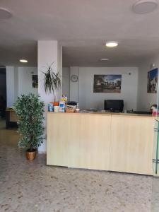 an office with a reception desk with a potted plant at Nerja Villas-Capistrano in Nerja