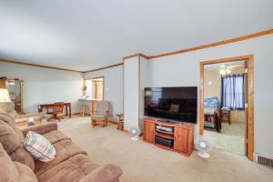 a living room with a couch and a flat screen tv at Peaceful Channing Retreat 3 Mi to Lake Access! in Channing