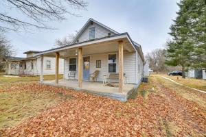 a small white house with a porch on a yard at Peaceful Channing Retreat 3 Mi to Lake Access! 