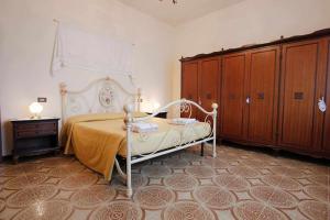 a bedroom with a bed and some wooden cabinets at Pierotta Country House Arezzo in Laterina