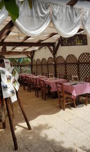 a row of tables and chairs under a tent at Agriturismo Nonna Luisa in Ferentino