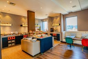 a large kitchen with a table and chairs in it at Hampton By Hilton Santiago Las Condes in Santiago