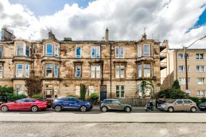 a group of cars parked in front of a building at Stunning 5 bedroom apt, close to city centre, SEC, Hydro and motorway in Glasgow