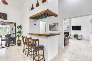 a kitchen and living room with a bar and chairs at Convenient Wellington Home Pets Welcome! in Wellington
