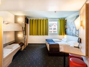 ヴァイル・アム・ラインにあるB&B Hotel Weil am Rhein/Baselの二段ベッド2台と窓が備わる客室です。